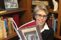 Librarian Eileen Corbett holding a storybook